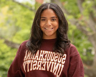 Shannel Jimenez '27 posed for a photo wearing a Susquehanna University sweater.